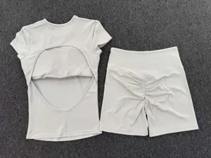 Grey open back short sleeve yoga top and ruched fitness shorts activewear set for women