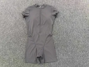 Close-up detail of the short-sleeve front-zipper one-piece grey yoga bodysuit texture.