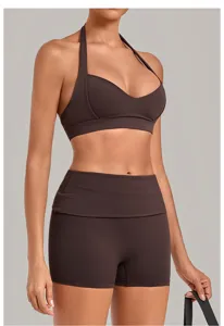 Detail view of brown halter sports bra and high waist yoga shorts set, flexible fit.
