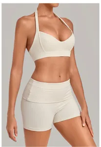 Beige halter yoga sports bra and high waist shorts detail, breathable fitness workout activewear.