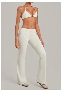White halter crop top and folded waist flare yoga pants set, perfect for workout and gym fitness.