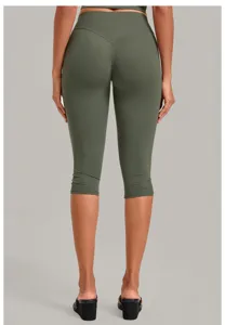 Back view of women's olive green high-waist capri yoga pants featuring a flattering contour seam.