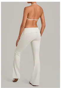 White halter top and fold-over flare yoga pants set, comfortable gym fitness activewear.
