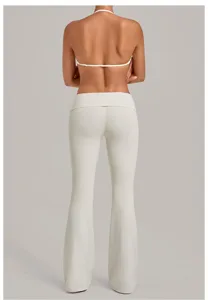 White halter bra and fold-over flare yoga pants set for fitness and workout training.