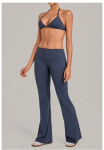 Detailed view of dark blue halter sports bra and fold-over flare yoga pants set for fitness.