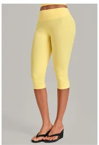 Detail view of yellow high-waisted capri yoga pants for women, highlighting shapewear fit.