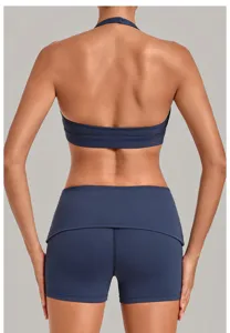 Back view detail of the dark blue halter neck sports bra and matching athletic yoga shorts.