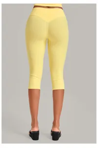 Back view detail of yellow yoga capri pants, high waist tummy control fitness activewear.