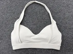 Close-up detail of white halter sports bra, stylish deep v-neck yoga top for fitness.