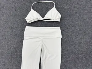 White halter sports bra and fold-over waist yoga pants set, perfect for fitness and active workouts.