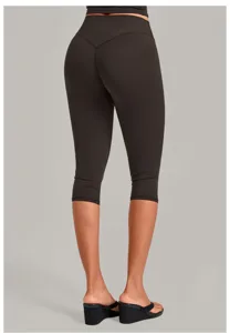 Detail view of women's athletic capri yoga pants showing back V-seam shaping and cropped fit.