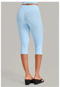 Light blue cropped yoga top and capri leggings set, detailed back view for fitness.