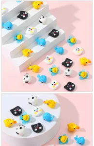 Close up detail of colorful glass animal beads featuring cute cats ducks pandas and whales.