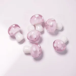 Detailed shot of pink glass mushroom beads, cute DIY charms for handmade bracelets and necklaces.