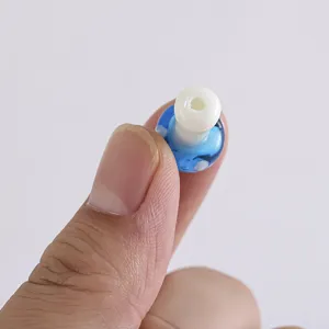 Close-up detail of the blue and white glass mushroom bead accessory for DIY jewelry.