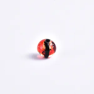 Red and black crystal glass bead detail showing glossy transparent texture for DIY jewelry.