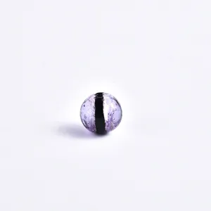 Macro detail of purple glazed glass bead with black stripe, perfect for DIY jewelry making.