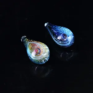 Detailed close-up of handmade starry sky glass tear-drop pendant with galaxy interior.