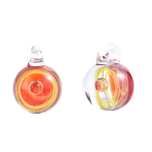 Detailed shot of handmade glass space galaxy pendant with red and yellow swirl patterns inside.