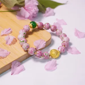 Vintage frog skin glazed glass bead bracelet with jade and gold charm, elegant peach blossom style.