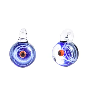 Close up of handmade galaxy glass orb pendant featuring a deep blue universe and swirling nebula.
