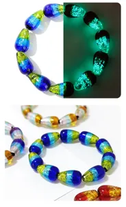 Detailed view of luminous gradient glass teardrop beads bracelet, colorful unique jewelry.