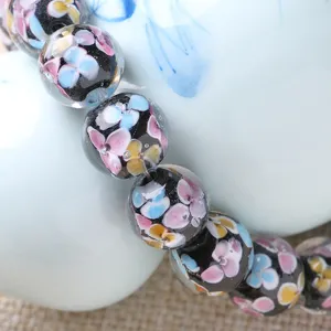 Handmade glass floral beads detail close up, colorful petal pattern DIY jewelry accessory
