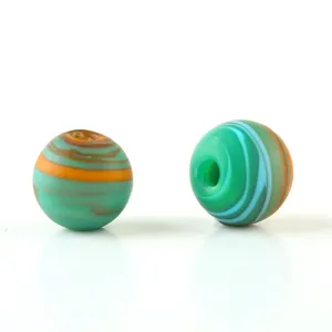 Frosted mixed silk glass beads close-up, colorful spiral patterned round beads for jewelry making.