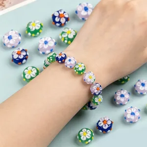 Handmade lampwork glass bead bracelet featuring colorful floral designs and loose beads.