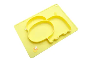 Close-up detail of cute yellow elephant silicone baby divided plate and food placemat.