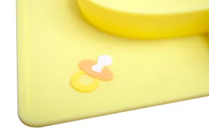 Silicone baby plate detail close-up, yellow material, cute pacifier embossed design.