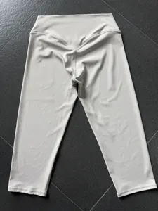 Detail shot of grey women high waist yoga cropped pants, showing hip lifting design.