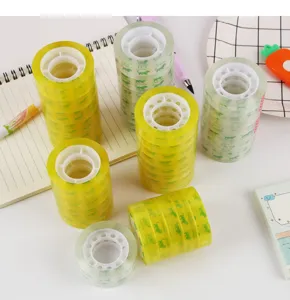 Clear stationery adhesive tape detail shot, transparent packaging tape rolls displayed on desk.