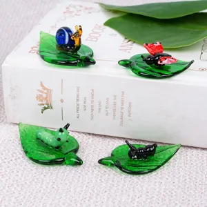 Cute glass insect figurines on leaf decor, handmade miniature animal statues for desk and office.
