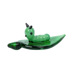 Green caterpillar on leaf glass figurine, creative desktop ornament for home or office decor.