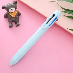 Detailed close-up shot of a pastel blue multi-color press ballpoint pen on a pink background.