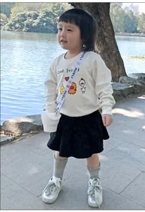 Portable silicone snack cup detail in outdoor scene with kid wearing daily outfit, safe design.