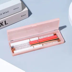 Detail view of pink translucent pencil storage box with crystal rhinestone marble pens inside.