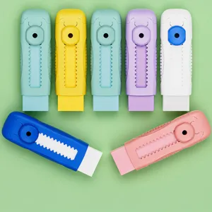 Primer plano detallado de gomas de borrar tipo pulsador en varios tonos pastel para papelería.