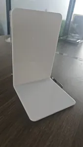 White plastic L-shaped bookend detail view for efficient desktop book organization and neat storage.