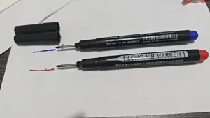 Detail view of long nib waterproof markers with metal tips for deep hole marking and woodworking.