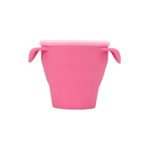 Portable silicone baby snack cup with double handles and lid, food grade pink baby bowl.