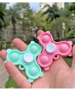 Push pop bubble fidget spinner toy detail view in mint green and pink bear shape.
