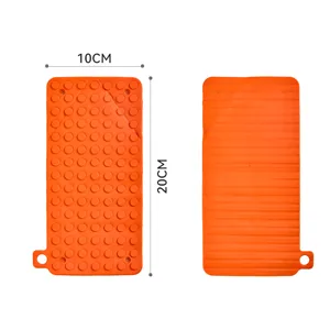 Orange silicone mat with anti-slip dots and stripes design, durable heat resistant pad 10x20cm
