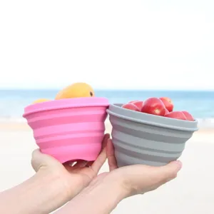 Close-up detail of collapsible silicone bowls showcasing telescopic design and outdoor fruit use.