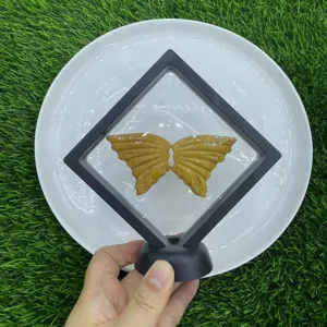 Detailed view of natural crystal gemstone butterfly wings carved specimen in floating frame.