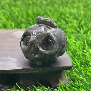 Natural gemstone carved pumpkin ghost head crystal detail view, perfect for Halloween collection.
