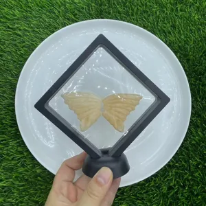 Crystal butterfly wings display detail shot, natural gemstone carving specimen in floating frame stand.