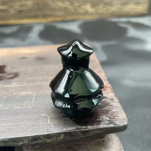 Close-up detail of the miniature polished black crystal Christmas tree stone carving.