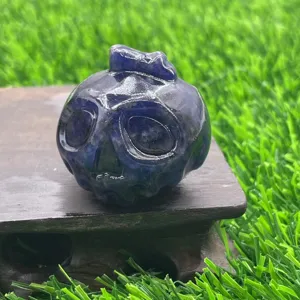 Detail shot of the 3.5cm natural gemstone carved pumpkin ghost skull crystal ornament close-up